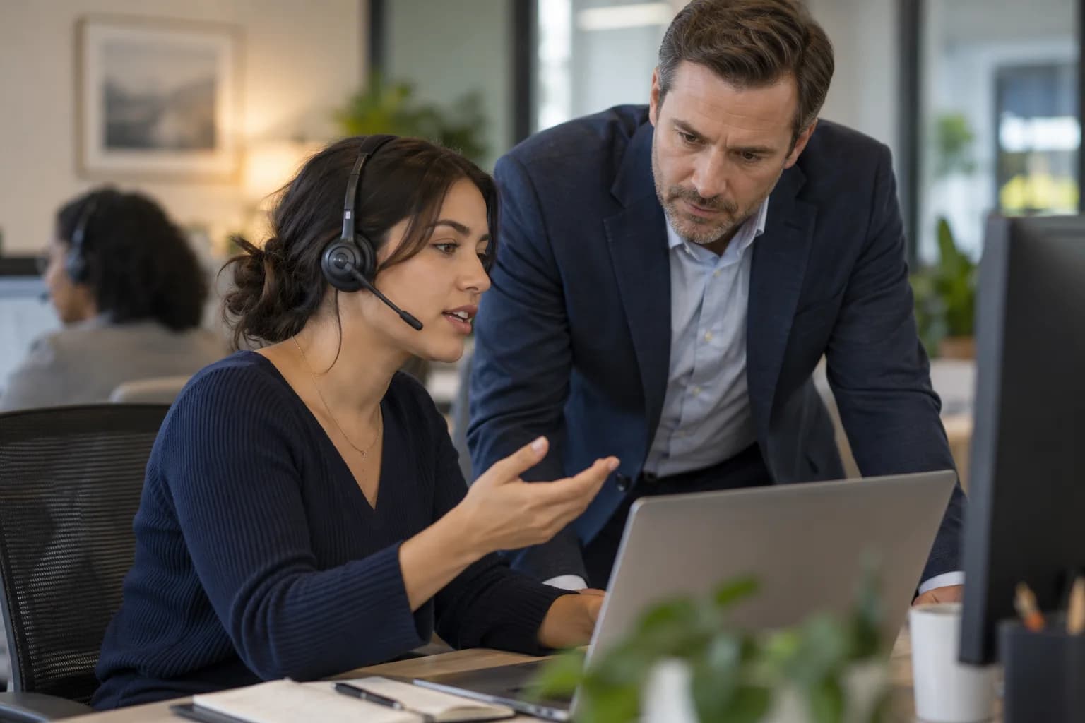 A support advisor discussing an enquiry with a supervisor