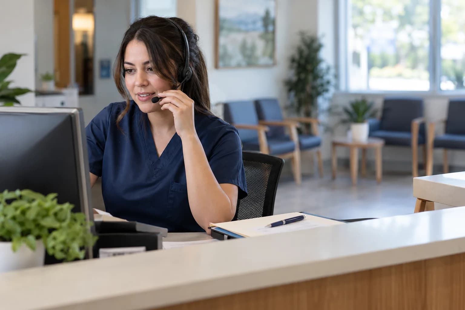 Clinic receptionist coordinating appointments by phone