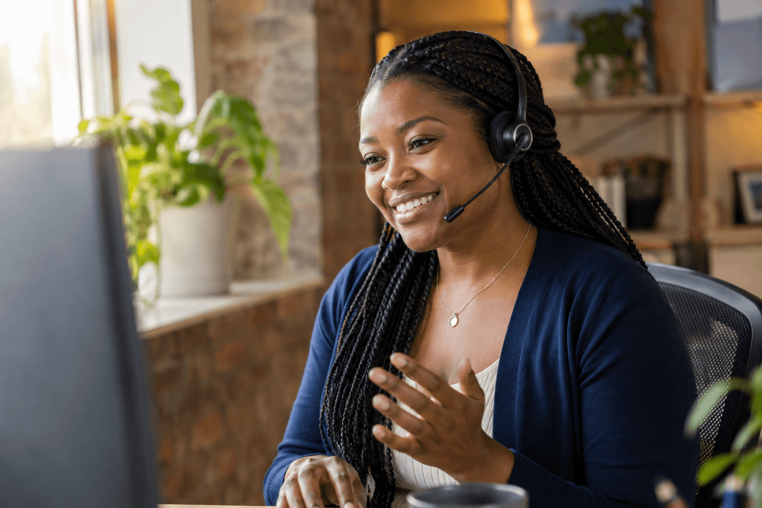 A customer support specialist helping a customer through her headset
