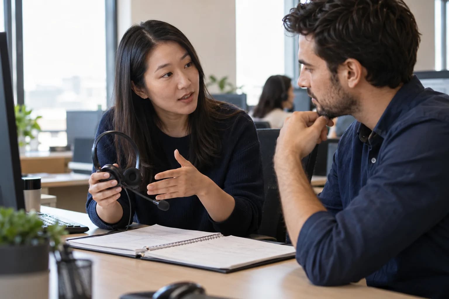 Customer support colleagues reviewing training notes